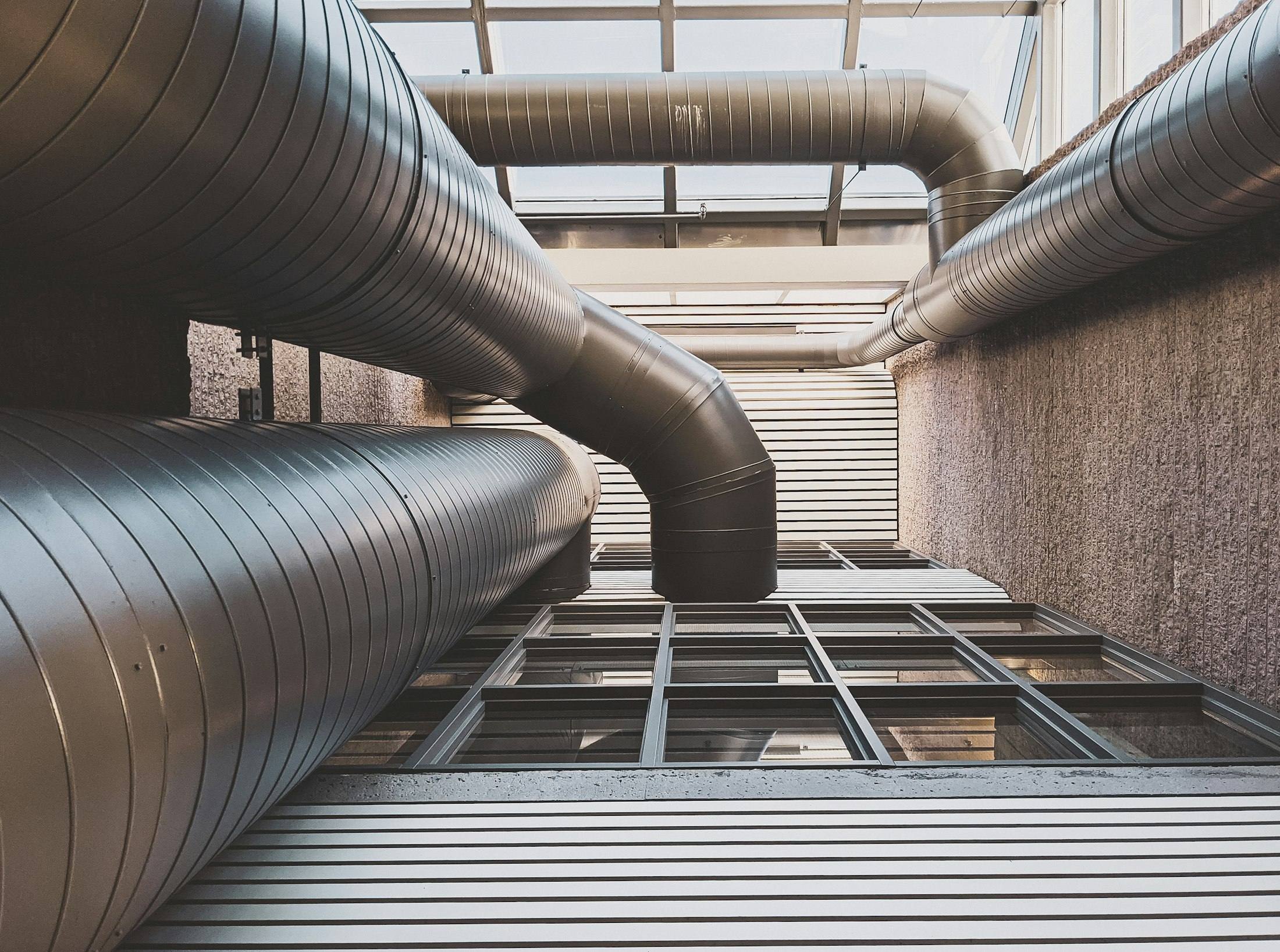 Insulated metal ductwork running overhead through a building