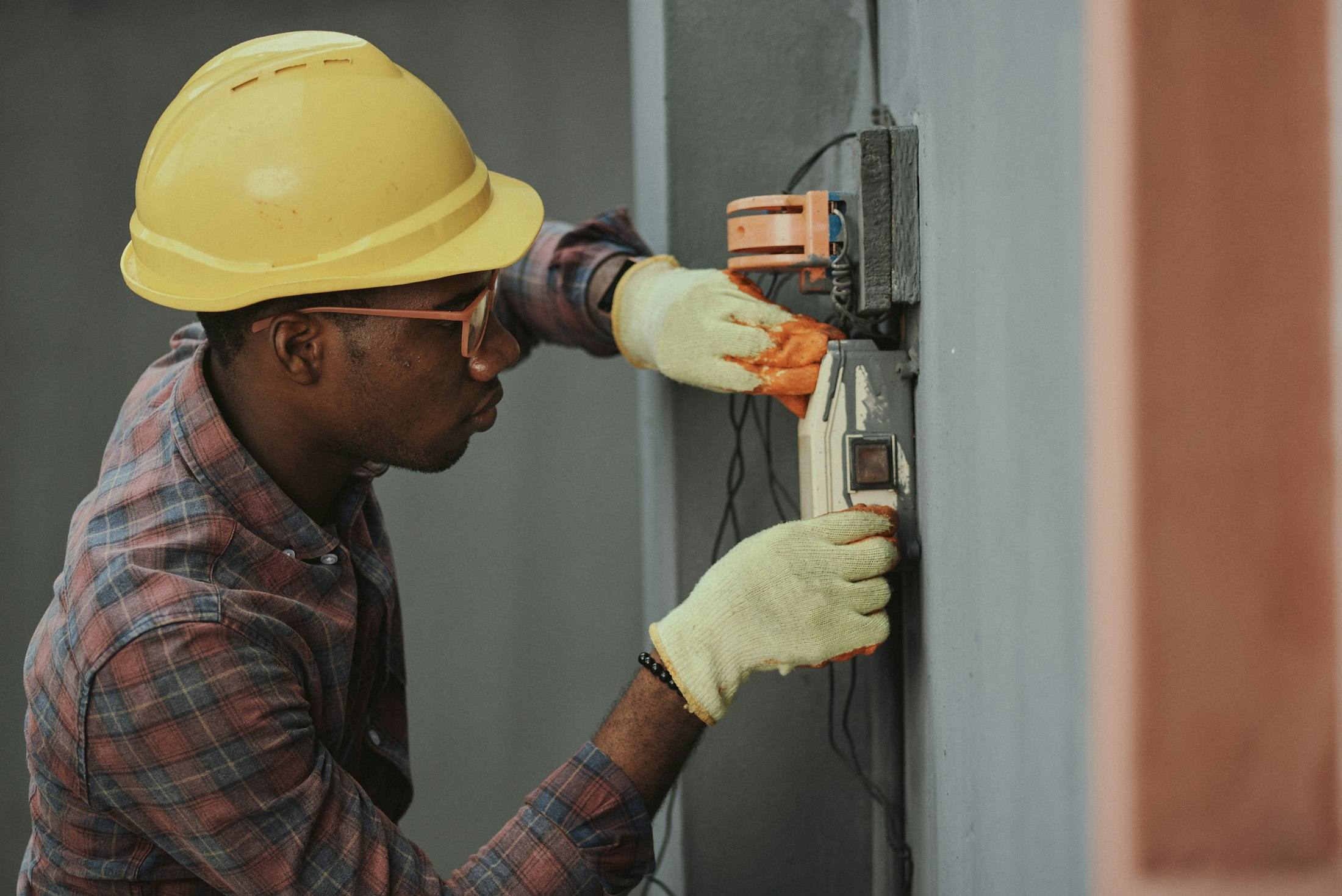 Technician in a hard hat working on equipment